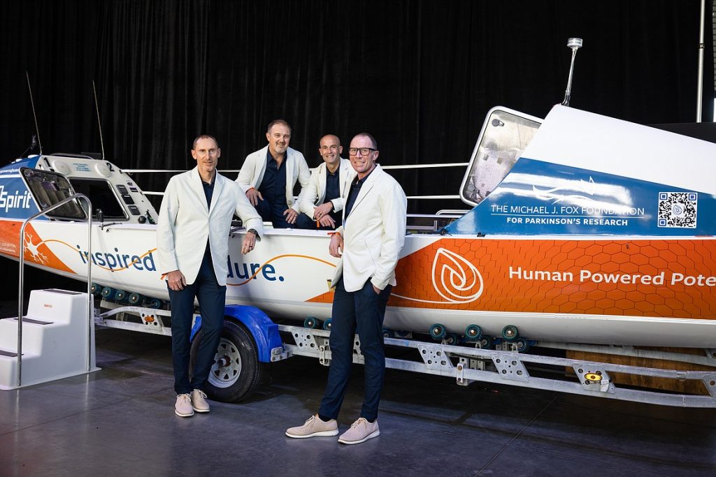 the HPP team in matching jackets standing next to their boat