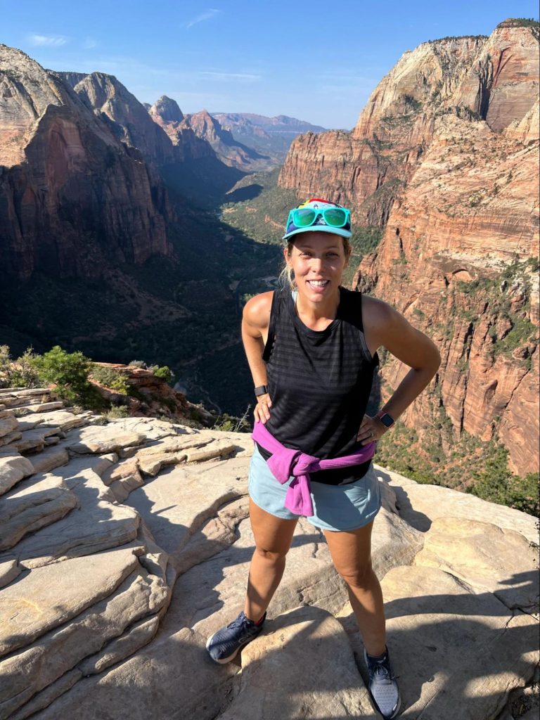 Ashley Ellis standing at top of canyon